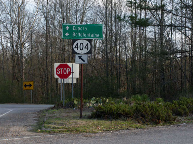 Some road signs but the important one is a sign that says 404