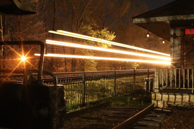 Long exposure of a train zipping past an old
train station at night.
